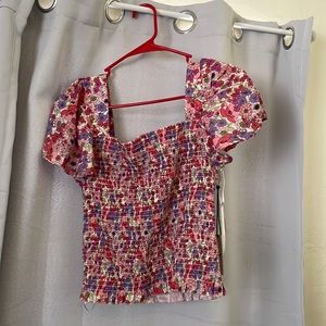 Cute stretchy shirt/blouse with flower pattern. Size medium. New with tags